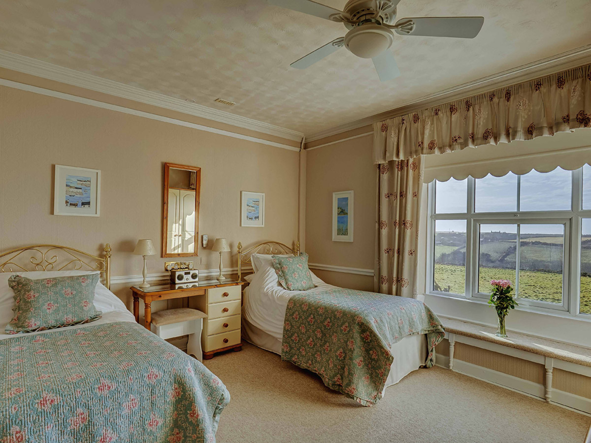 Twin bedroom with countryside views at Bosavern House