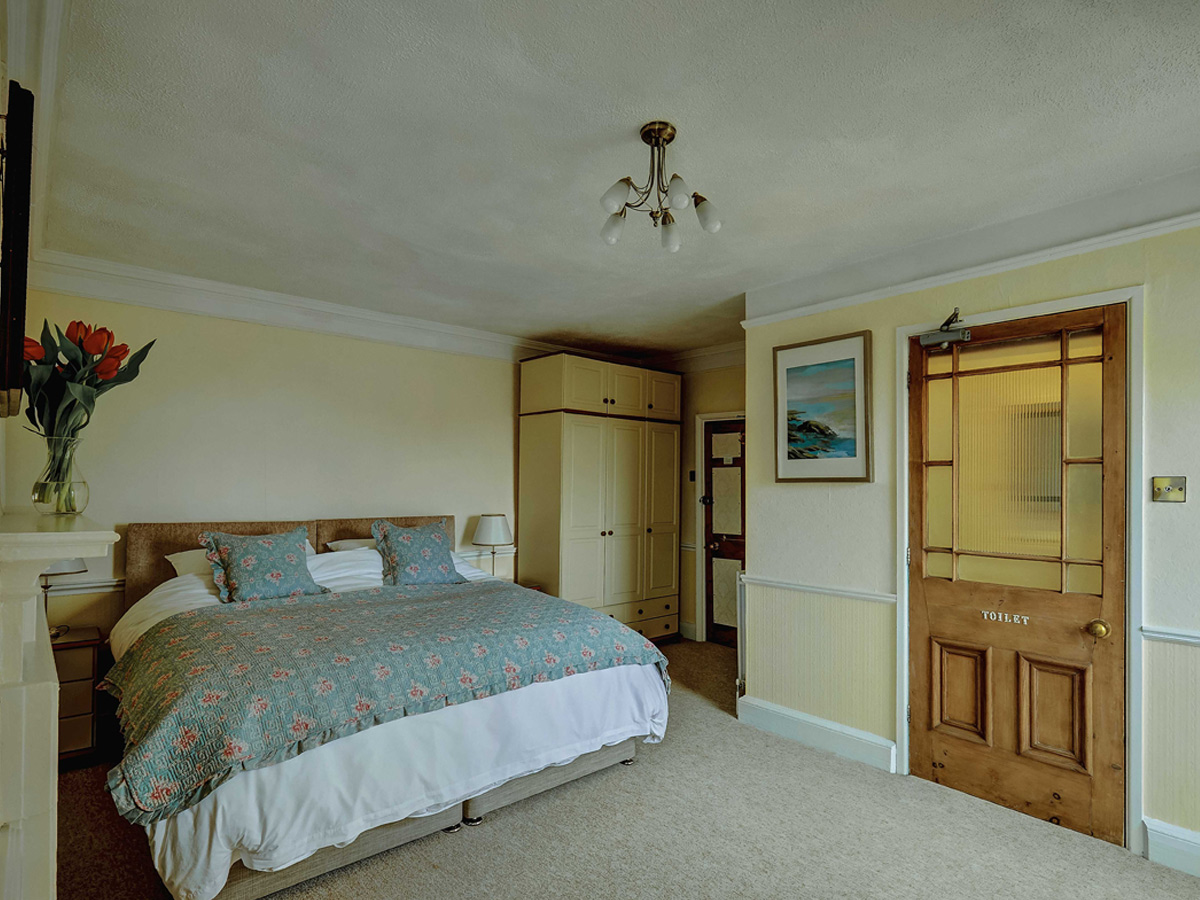 Double bedroom with period door at Bosavern House