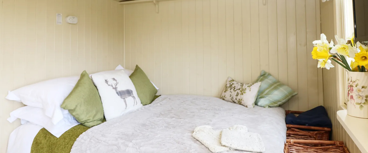 Double bed in a Pengelly Farm shepherd hut