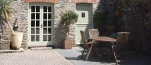 Quality self catering accommodation in a character barn conversion with beamed ceilings set in a secluded wooded valley near to Fowey.