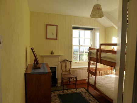 Bunk room with original fireplace