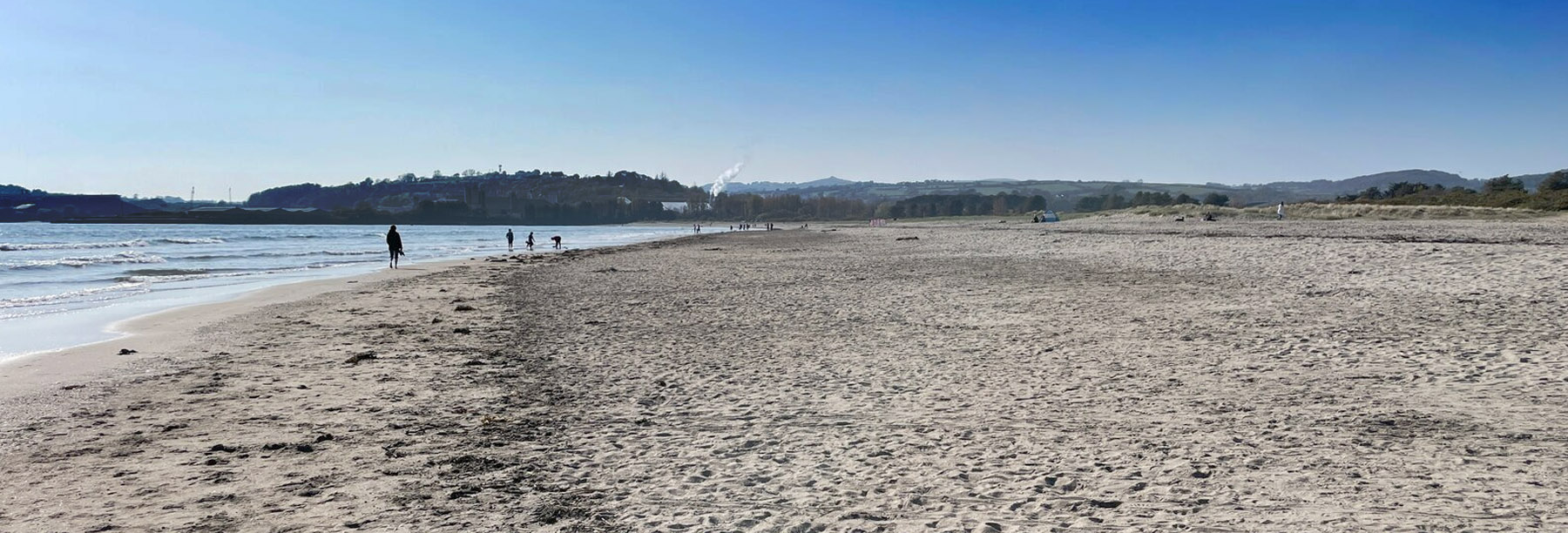 The flat, open expanse of Par Sands beach in St Austell Bay Cornwall