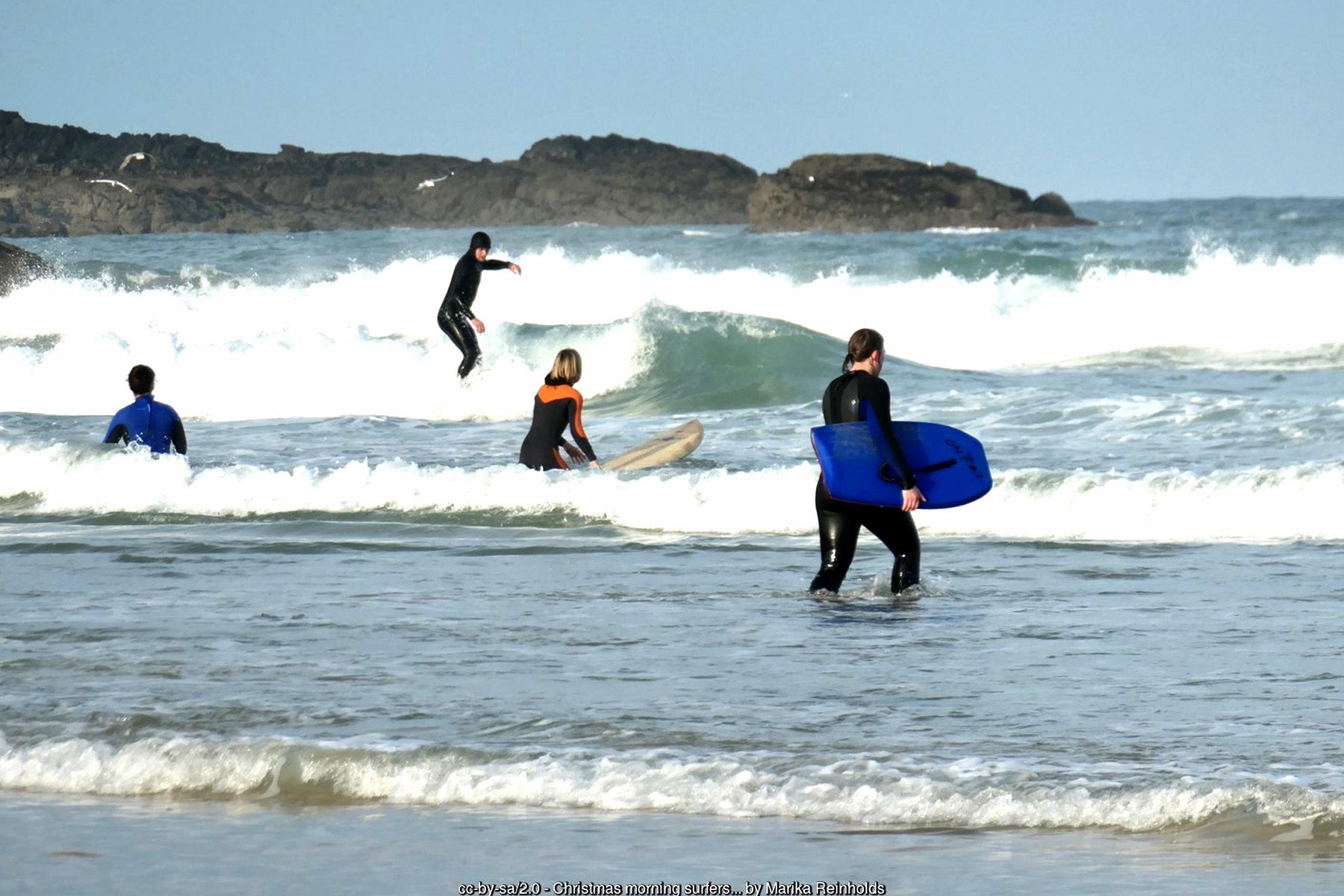 Surfers riding waves at Porthmeor Beach in St Ives,  Atlantic surfing   - Cornwall surf holidays