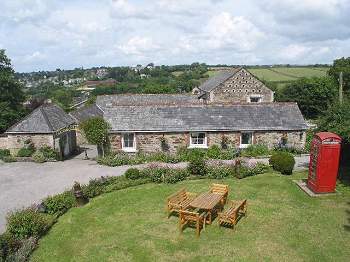 Lawned garden and stone cottages at Coldharbour Farm, Bodmin