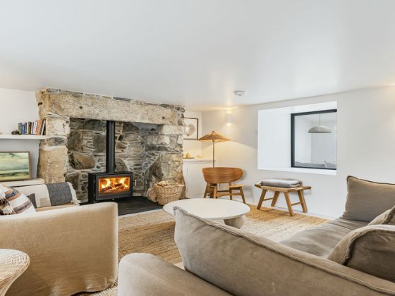 Towan lounge with stone fireplace and woodburner