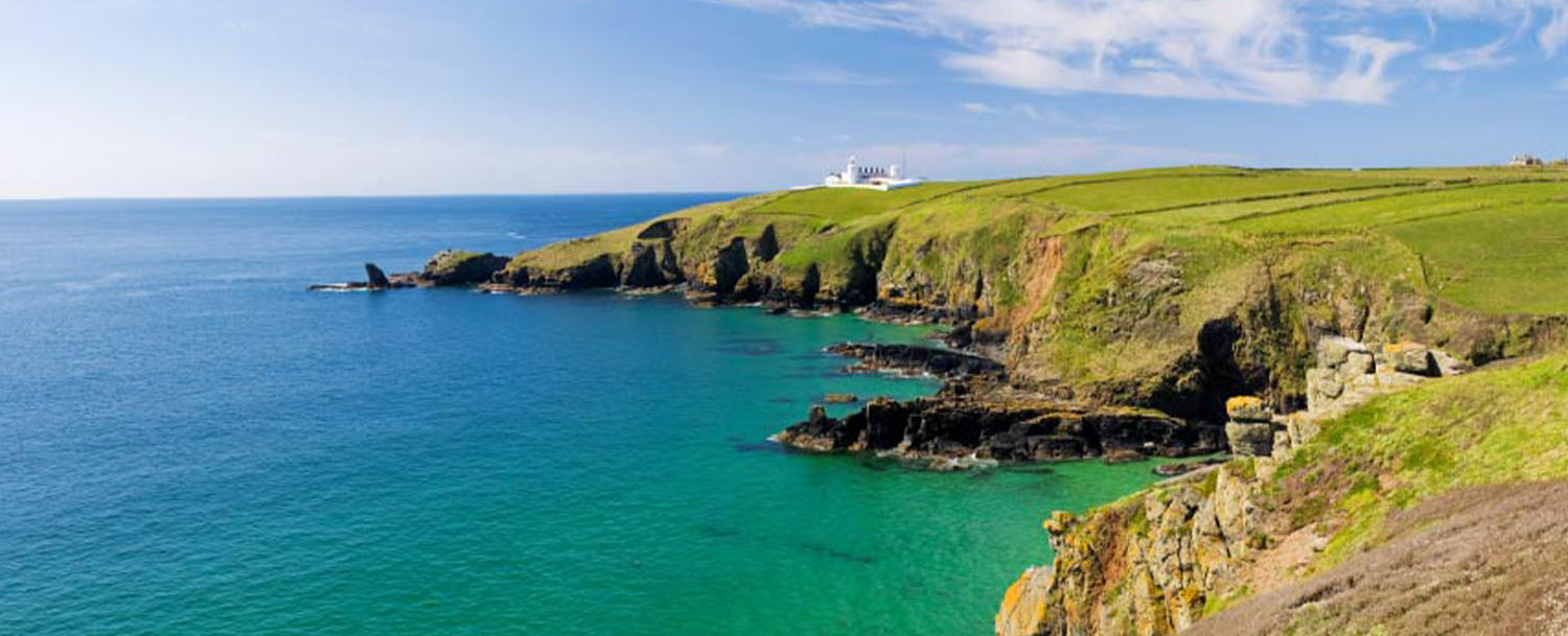 Lizard Point - the lighthouse on the cliffs above turquoise sea, the most southerly point of mainland Britain