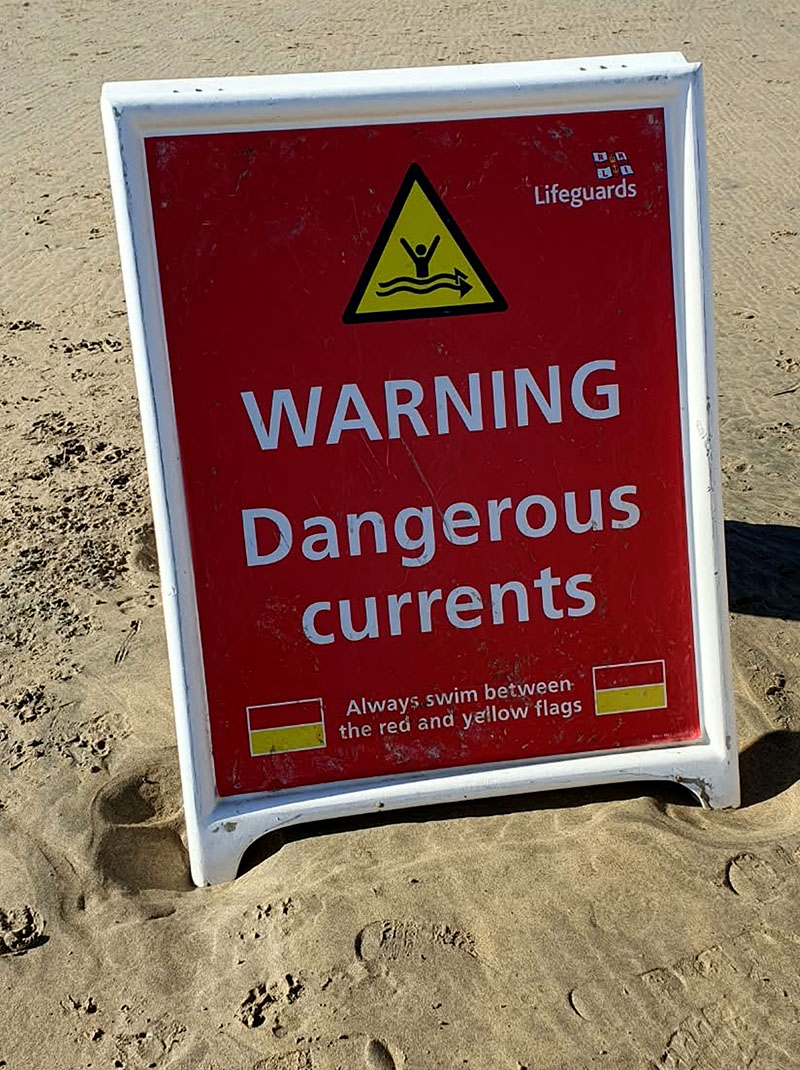 Perranporth lifeguards beach safety sign warning of dangerous currents