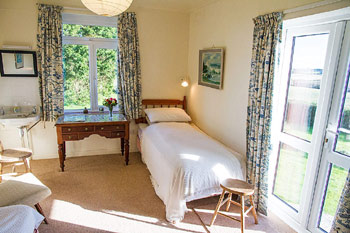 Bedroom with garden doors, Wesdale Holiday Cottage